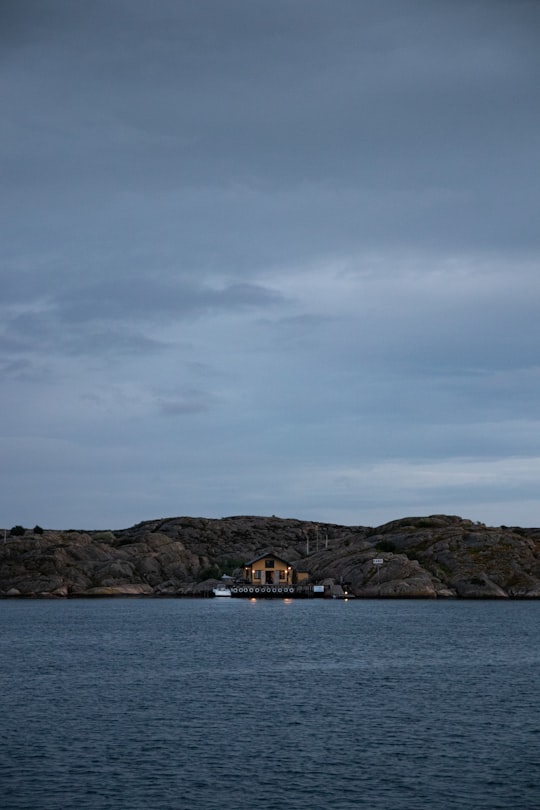 white and brown boat on sea under gray sky in Kungshamn Sweden