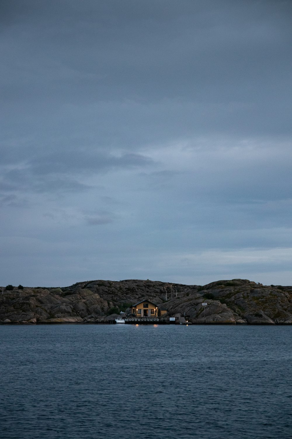 white and brown boat on sea under gray sky