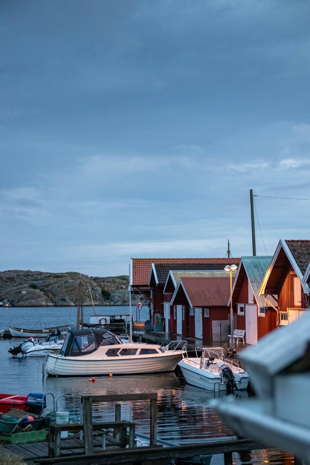 white and brown boat on dock near houses during daytime