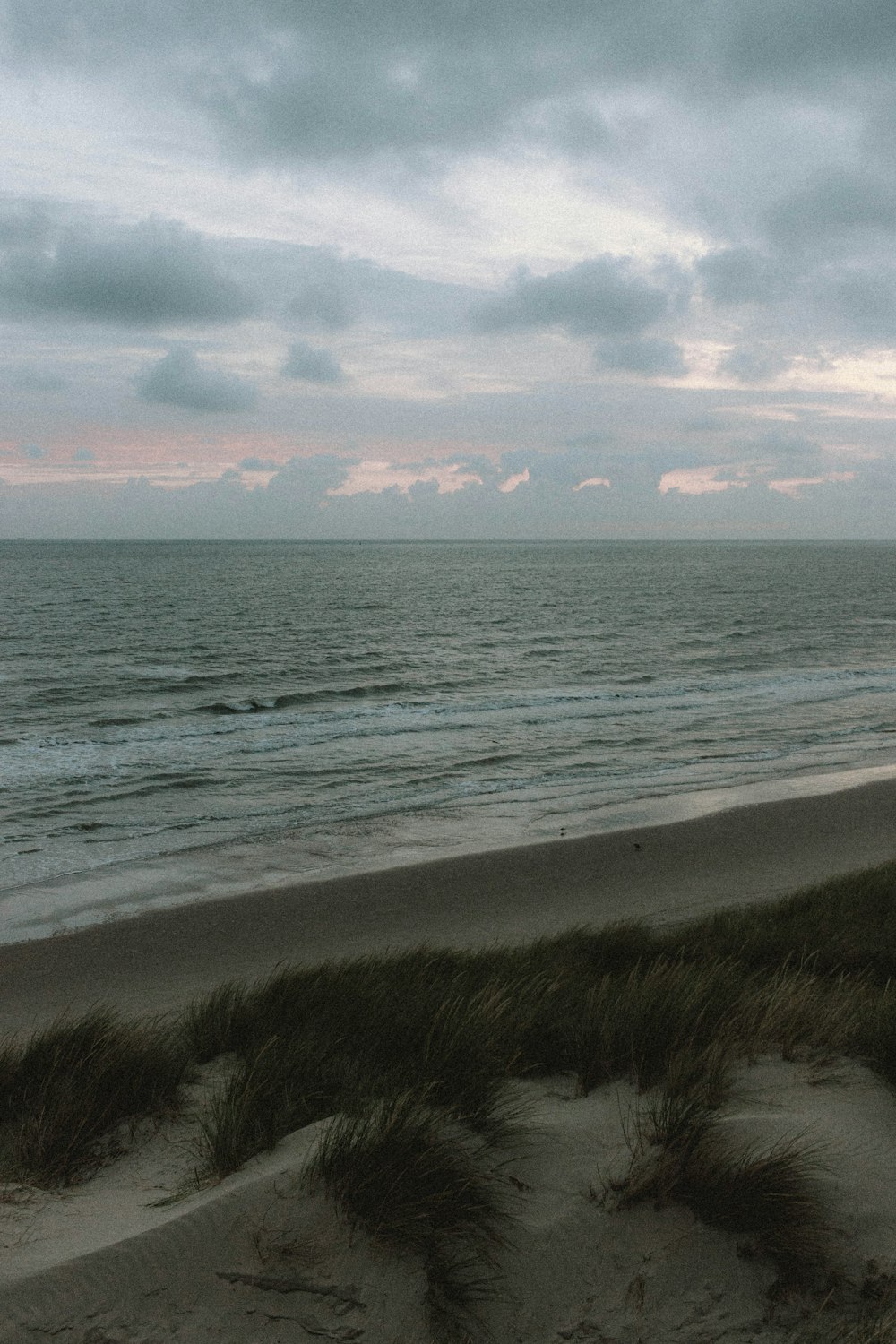 body of water under cloudy sky during daytime