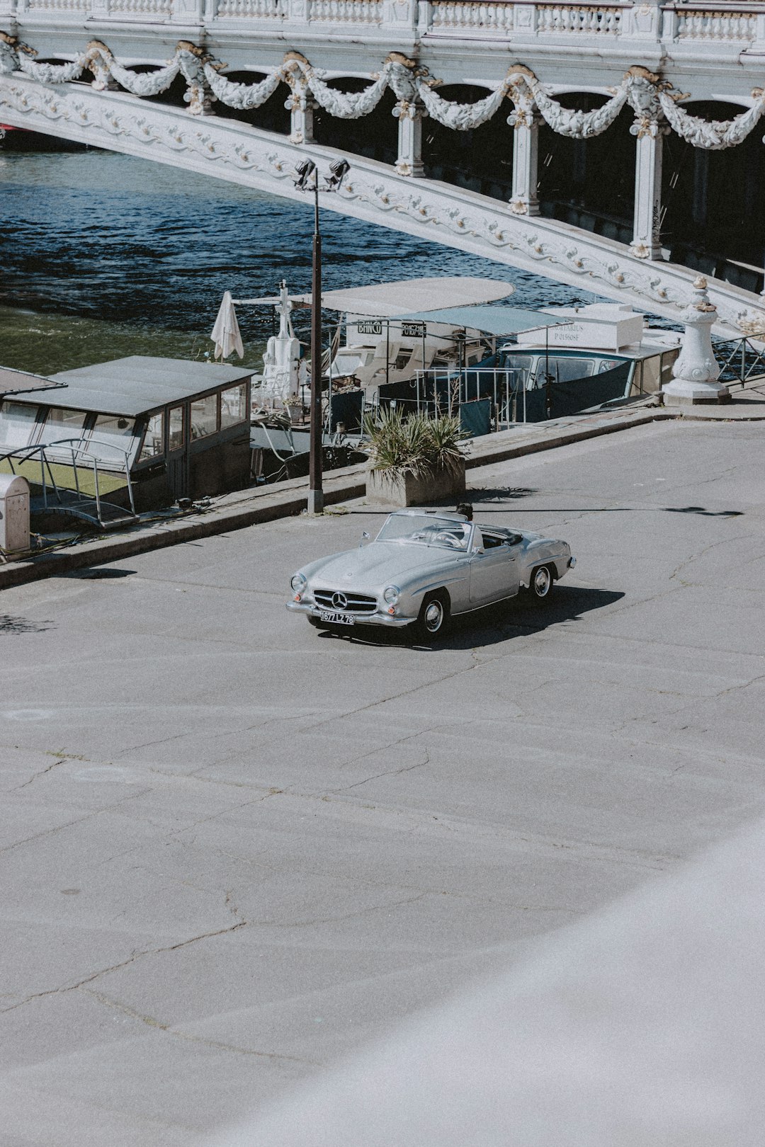 white coupe parked on sidewalk during daytime