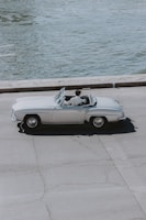 A stylish convertible cruising along a scenic road.