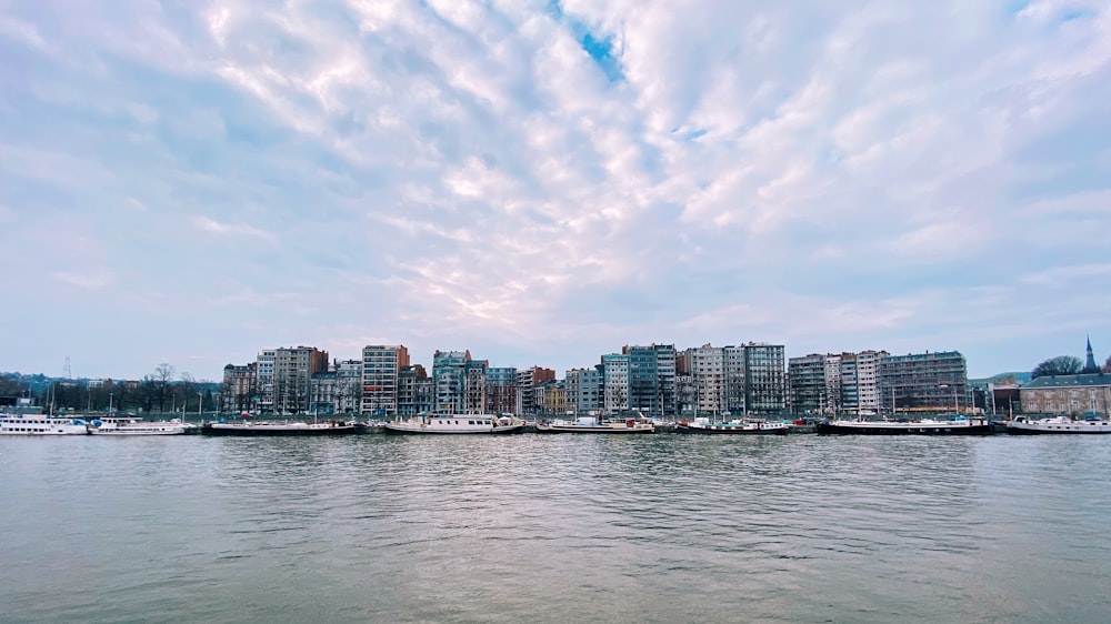 city skyline under white clouds and blue sky during daytime