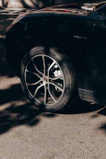 Shiny black tires freshly treated with dm cosmetic's tire shine gel reflecting sunlight.
