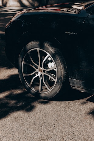 Shiny black tires freshly treated with dm cosmetic's tire shine gel reflecting sunlight.