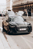A stylish black Creta parked in front of a modern cityscape.