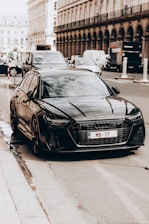 A sleek car parked on a city street ready to pick up passengers in a professional taxi service.