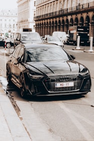 A sleek car parked on a city street ready to pick up passengers in a professional taxi service.