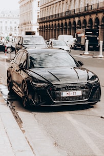 A sleek taxi car parked on a city street ready to pick up passengers.