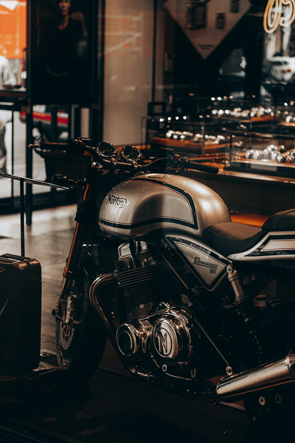 black and silver motorcycle parked beside black steel fence during night time