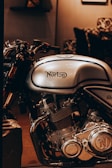 A vintage Norton motorcycle gleaming under soft museum lighting, evoking nostalgia.