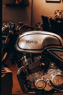 A vintage Norton motorcycle gleaming under soft museum lighting, evoking nostalgia.