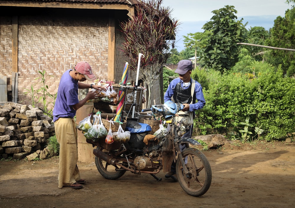 man in green shirt and brown hat riding motorcycle