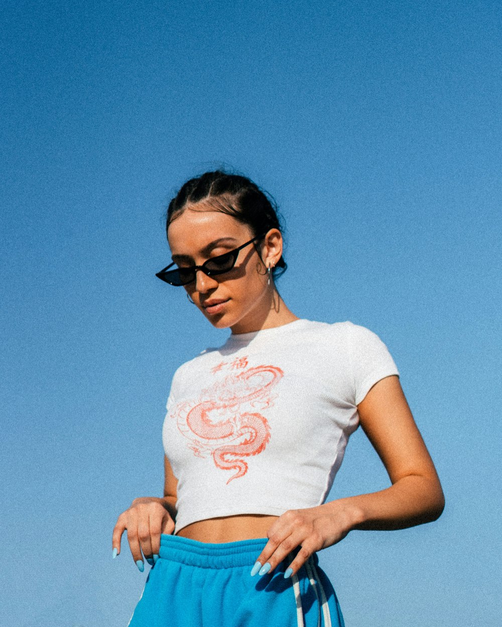 woman in white crew neck t-shirt and blue denim daisy dukes