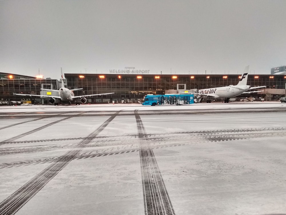 white and blue airplane on airport during daytime