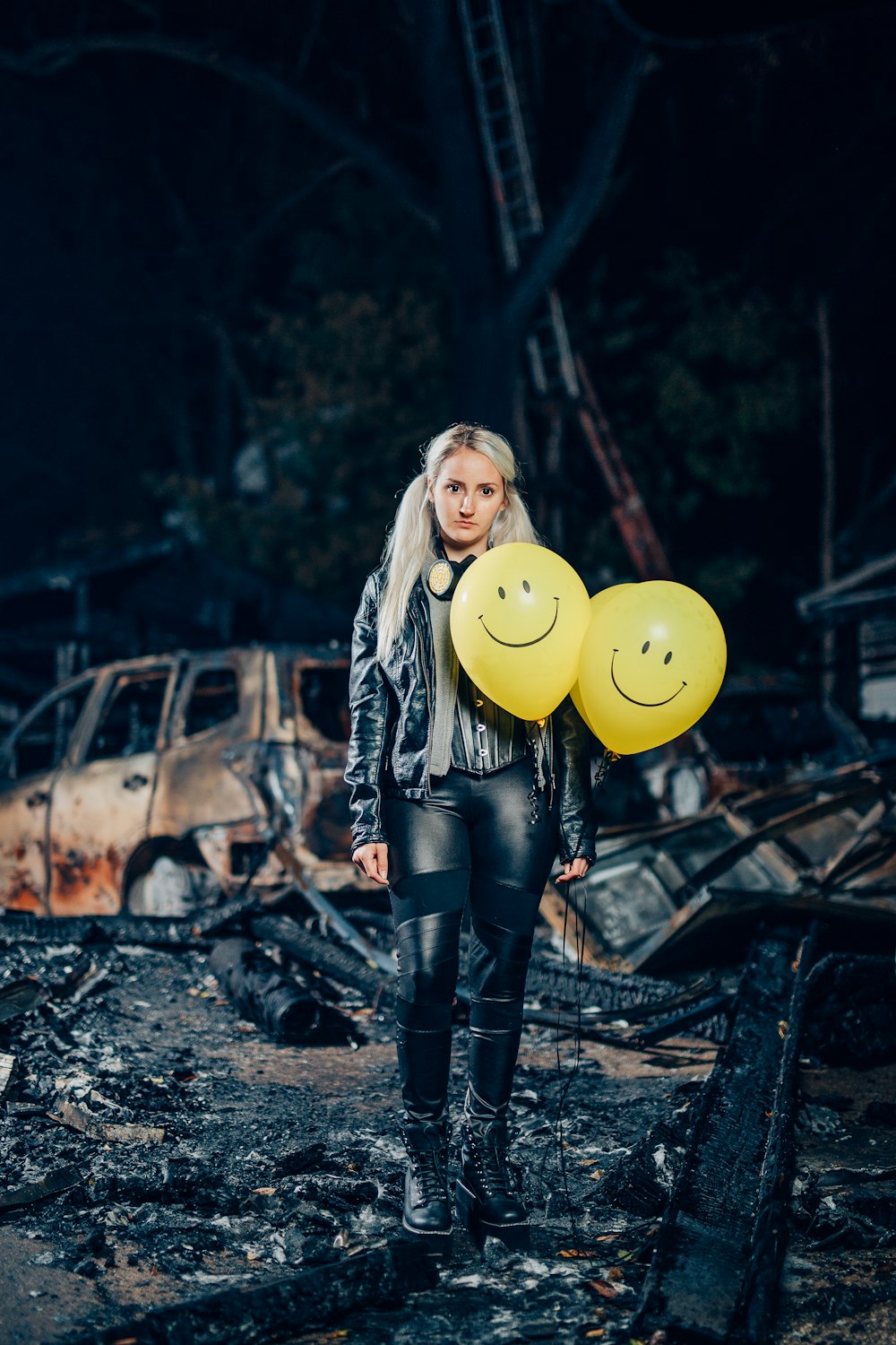 woman in black leather jacket holding yellow balloon