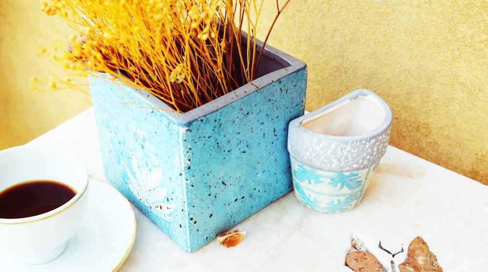 yellow flowers on blue and white ceramic vase