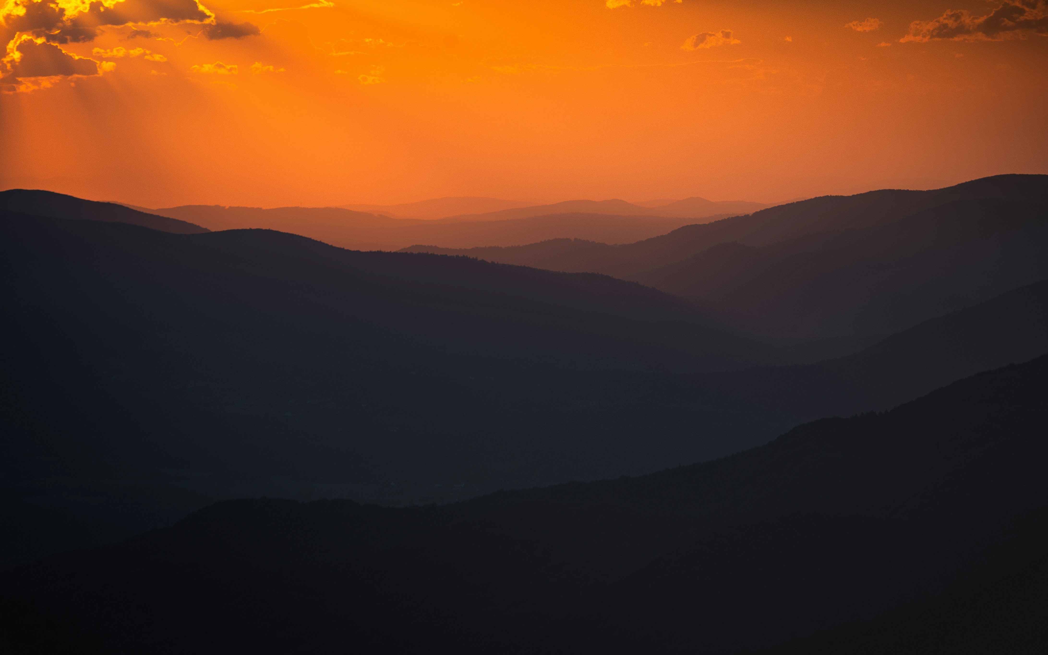 silhouette of mountains during sunset