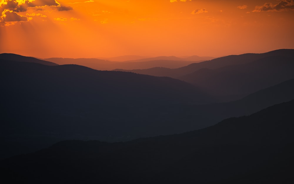 silhouette of mountains during sunset