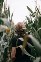 woman in black shirt standing on green grass field during daytime