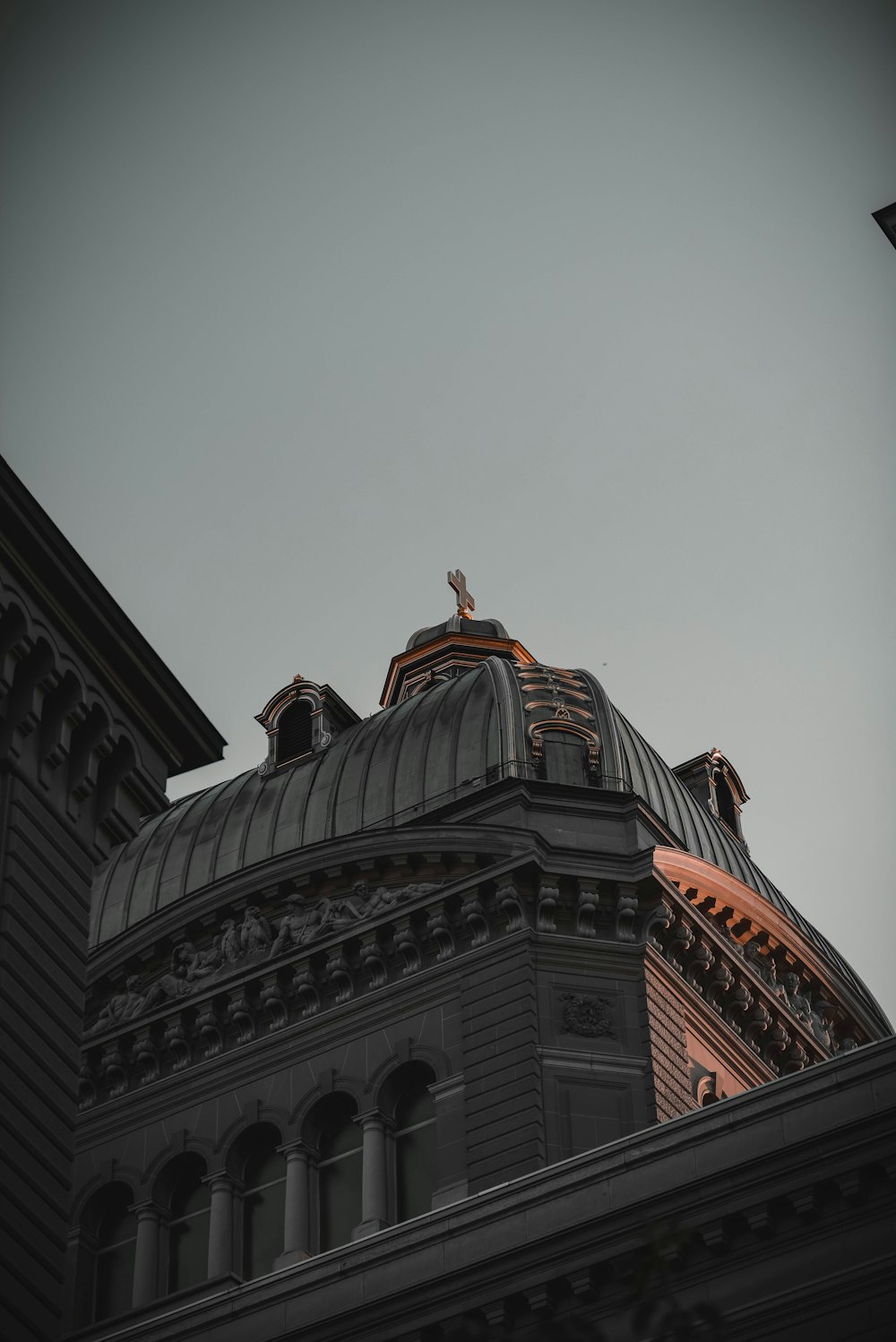 brown and white concrete building under white sky during daytime