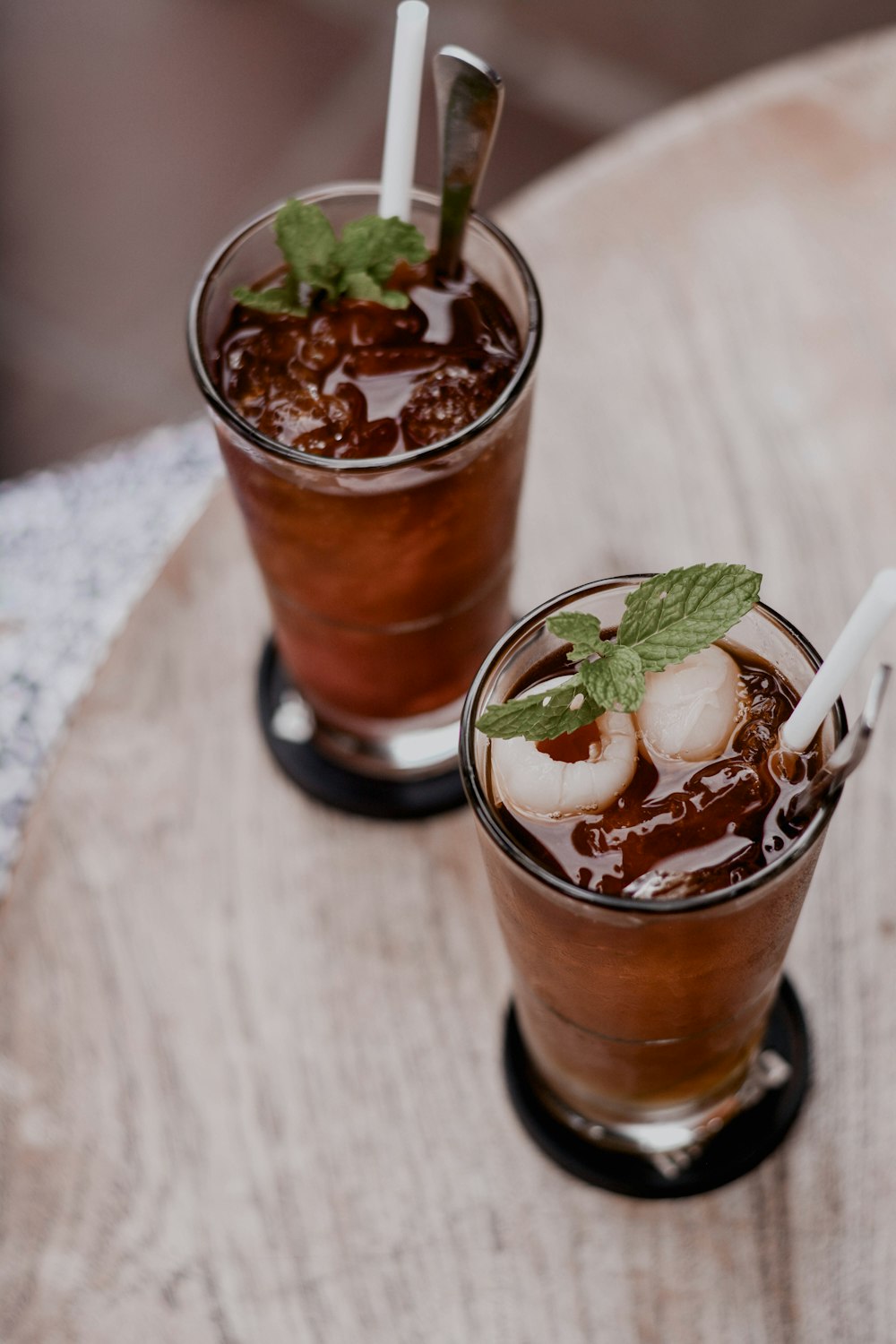 clear drinking glass with brown liquid and ice