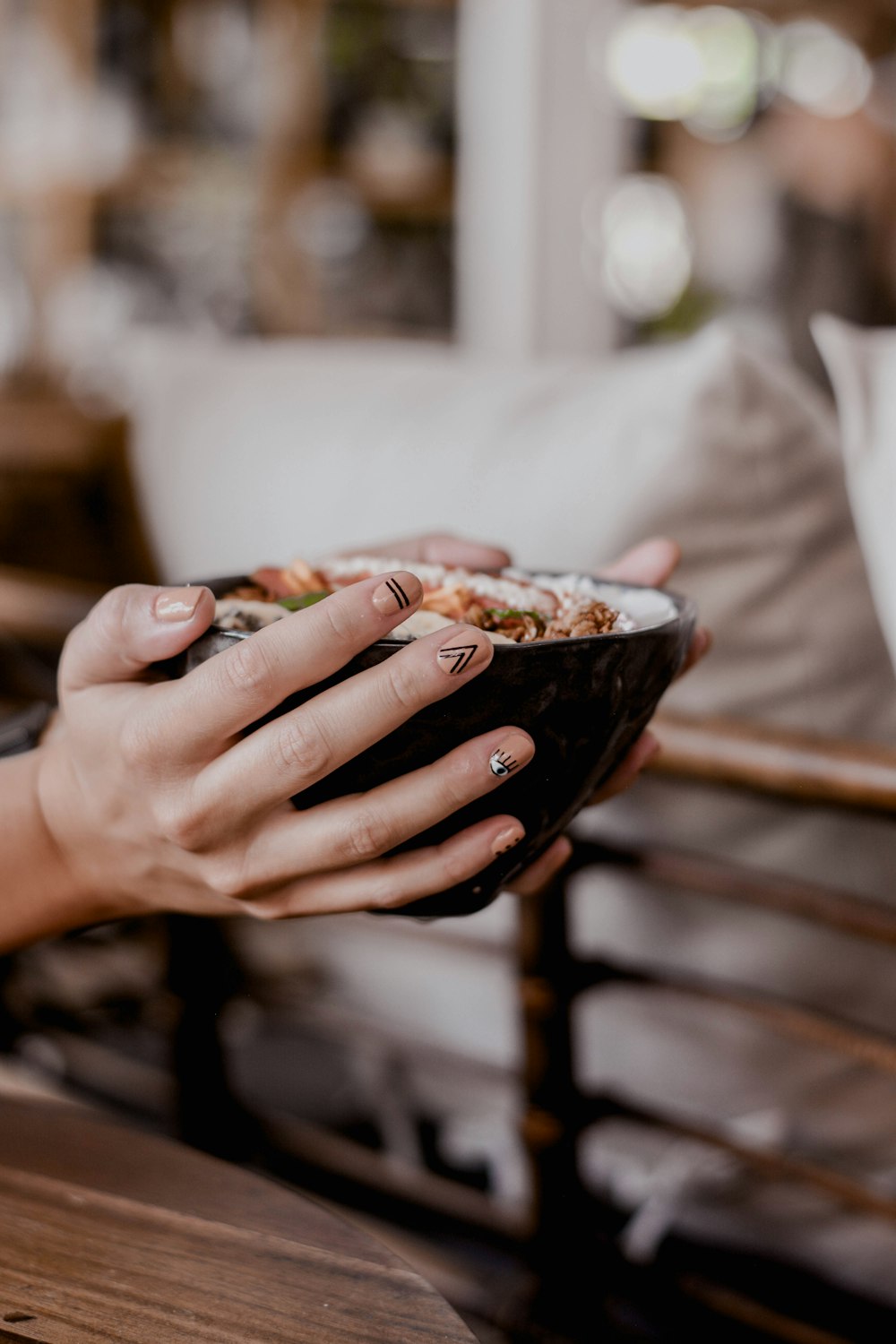 person holding bowl with food