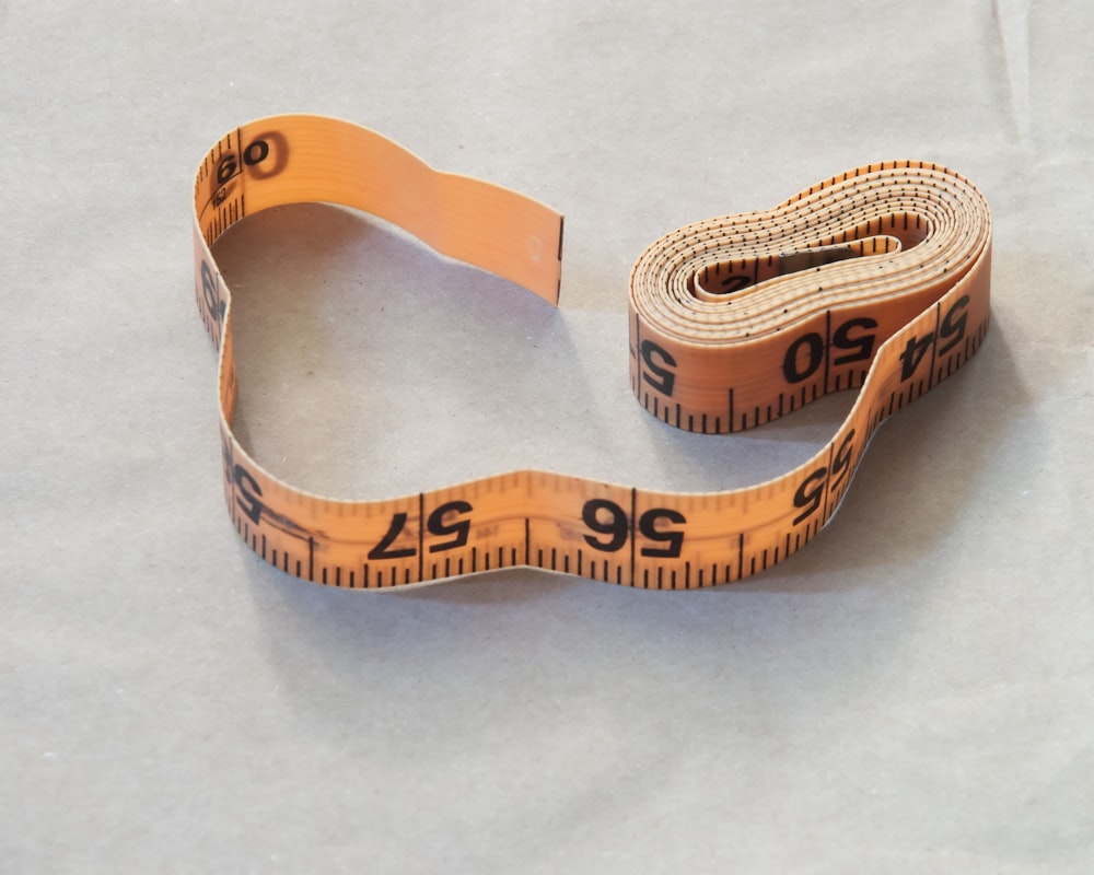 brown leather strap on white table