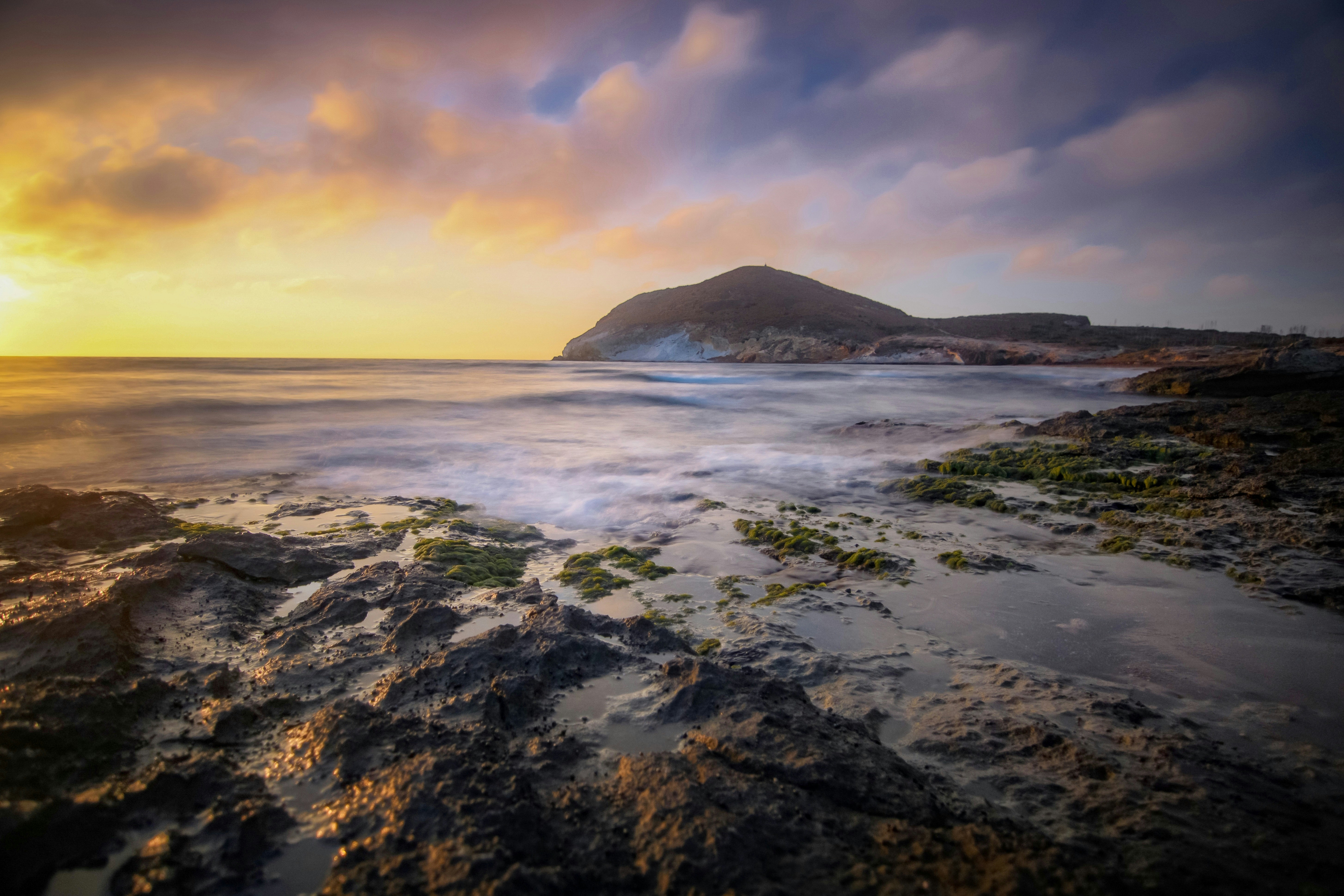 ocean waves crashing on shore during sunset, 