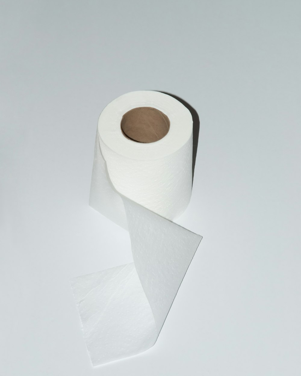 white toilet paper roll on white table