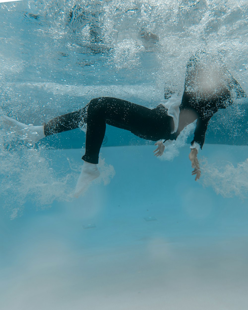 woman in black pants and white shoes on water