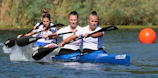 A close-up of young athletes practicing paddling techniques with focused expressions.