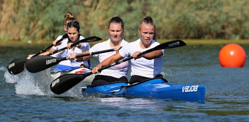 A vibrant group of women paddling together on Chatfield Reservoir during the Colorado Witch Paddle event.