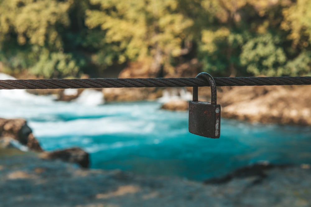 padlock on brown metal fence