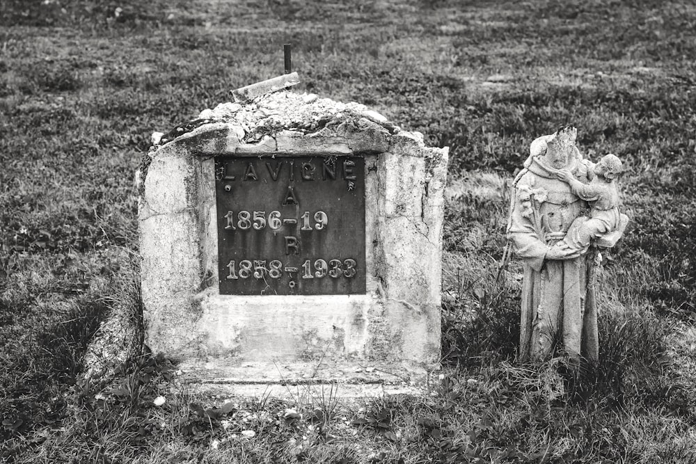 gray tomb stone on green grass field
