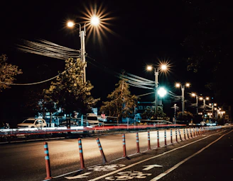 Technicians installing LED street lighting along a newly constructed urban road.