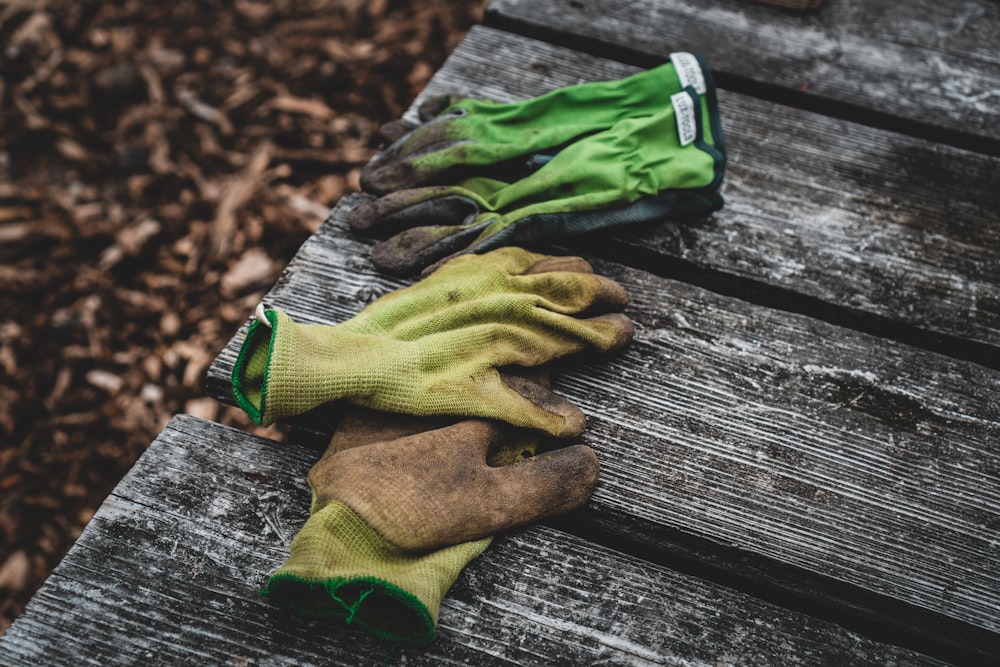 brown and green sock on gray wooden surface