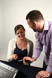 A man and woman consulting an AI-driven health assistant on a tablet together.
