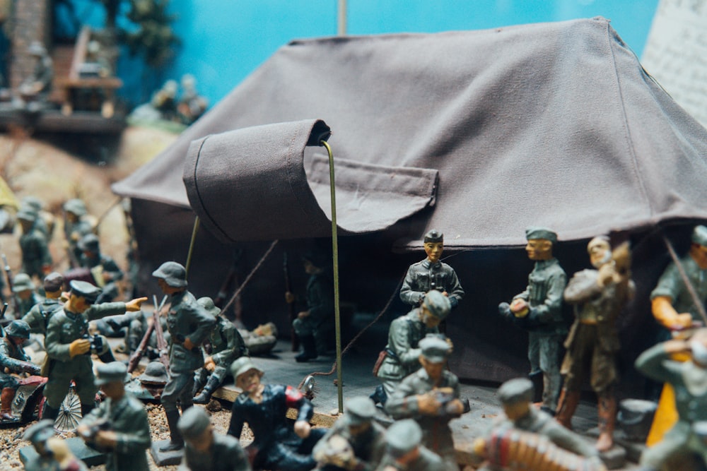 people in black and white uniform holding a flag figurine