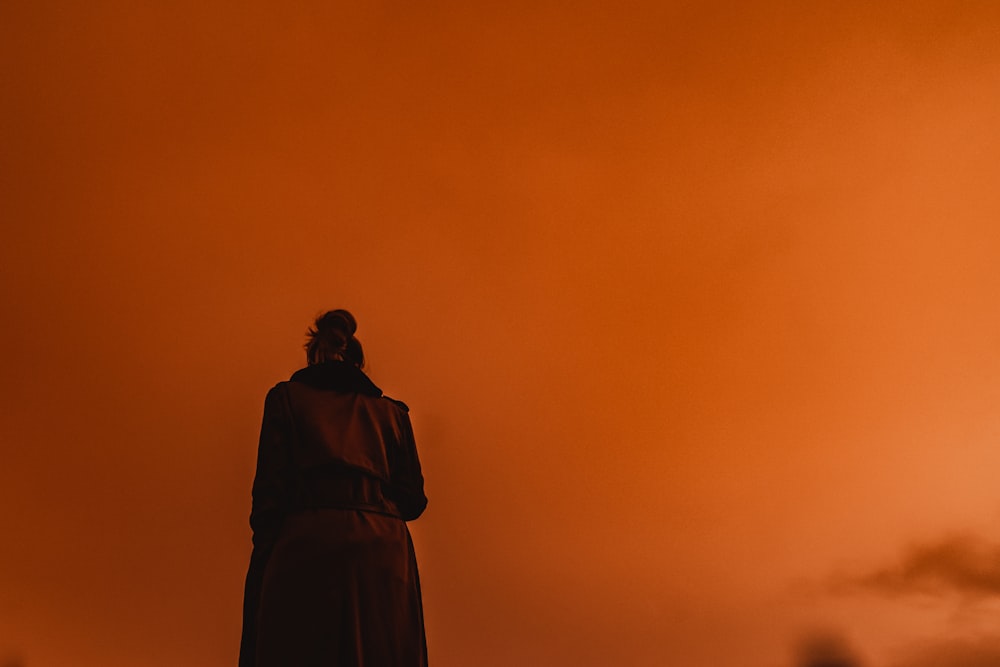 silhouette of man standing during sunset