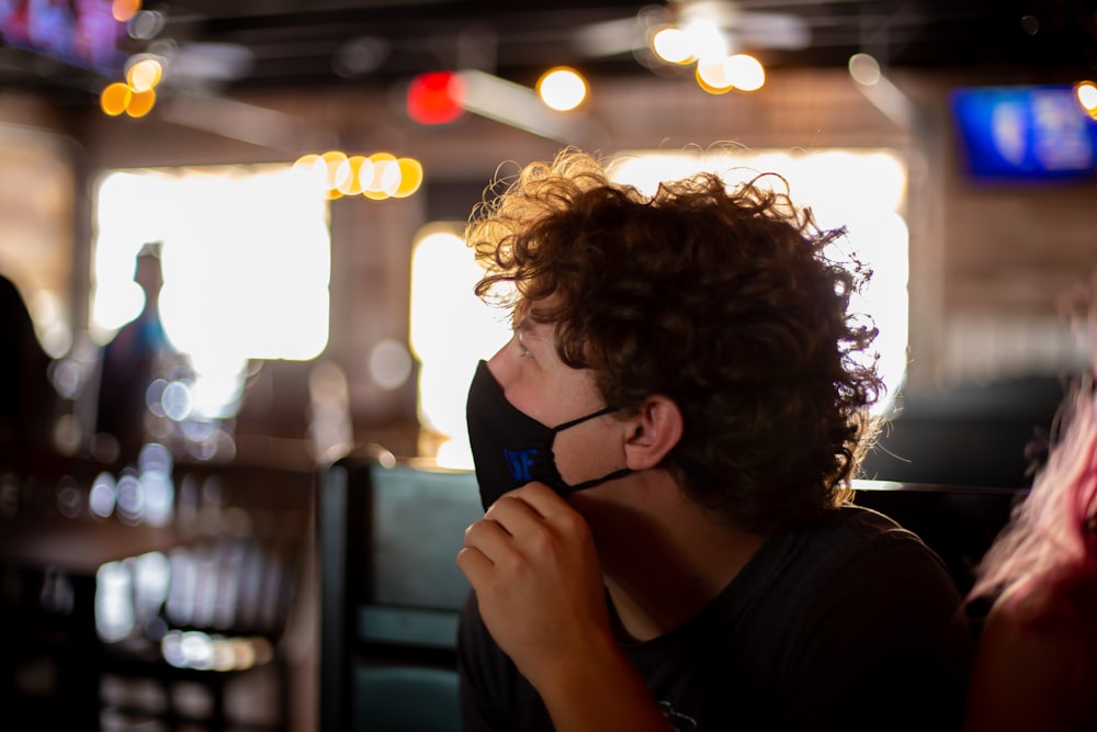 man in black crew neck shirt wearing black sunglasses