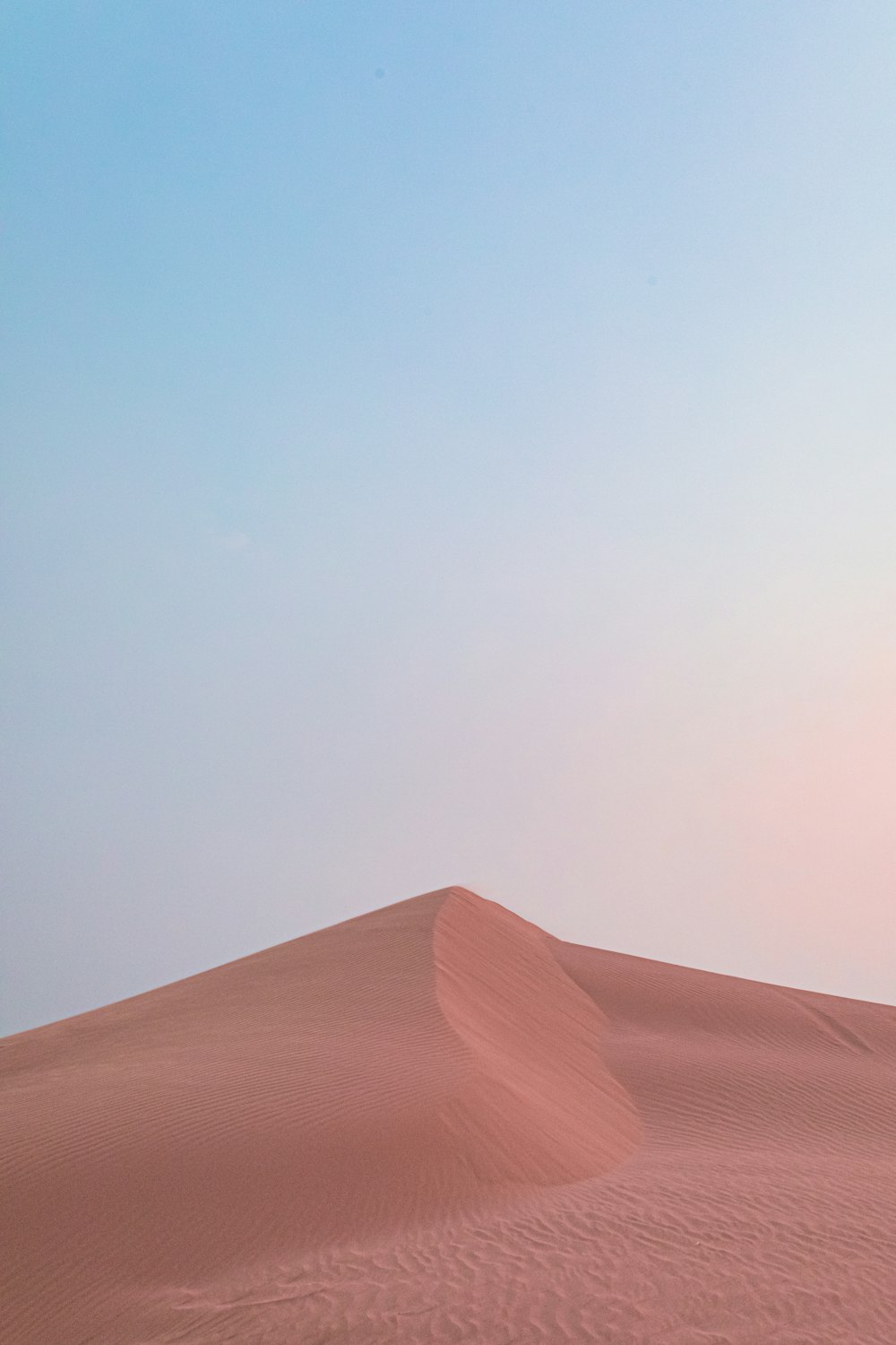 brown sand under blue sky during daytime