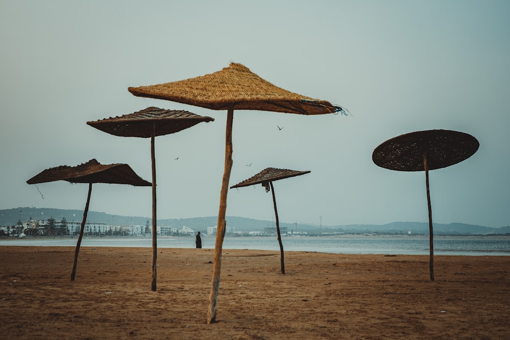 brown beach umbrella on beach during daytime