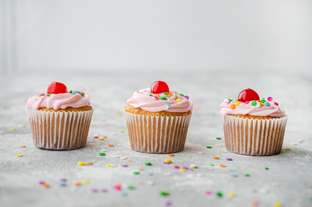 cupcakes with red and white icing on top