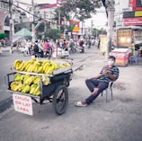 Close-up of a vendor using a smartphone to manage orders through the Town Growers Hub platform.