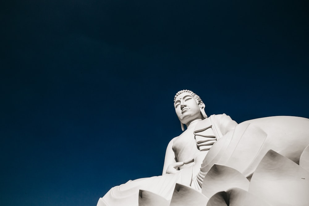 white concrete statue under blue sky during daytime