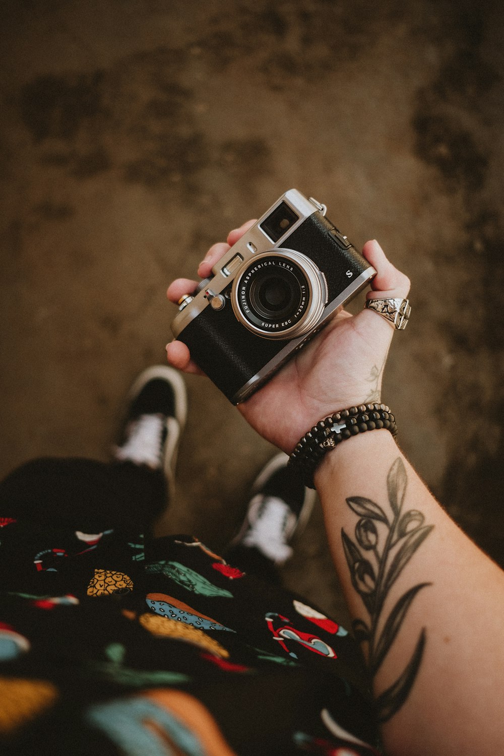 person holding black and silver camera