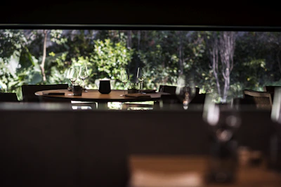 A serene dining setting with soft lighting, golden decor, and a hint of greenery.