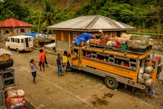 people standing near yellow and blue bus during daytime