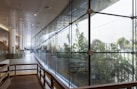 brown wooden bench near glass wall